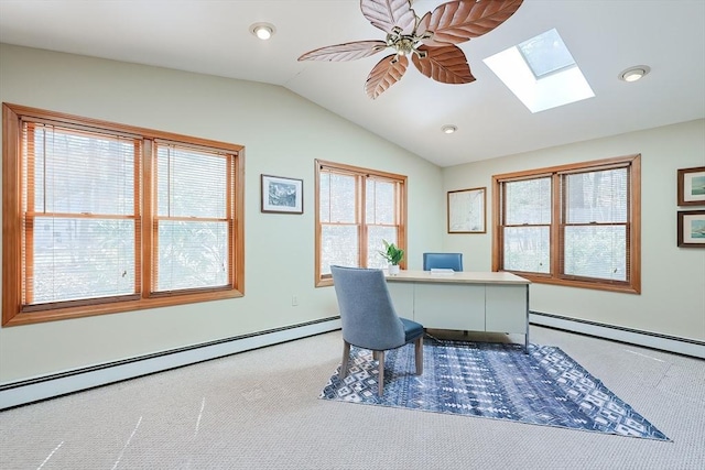 carpeted home office with vaulted ceiling with skylight, a ceiling fan, and baseboard heating