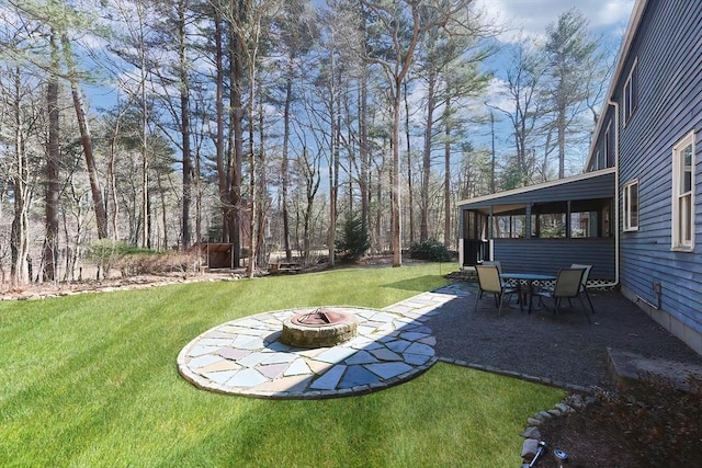 view of yard featuring a patio and a fire pit