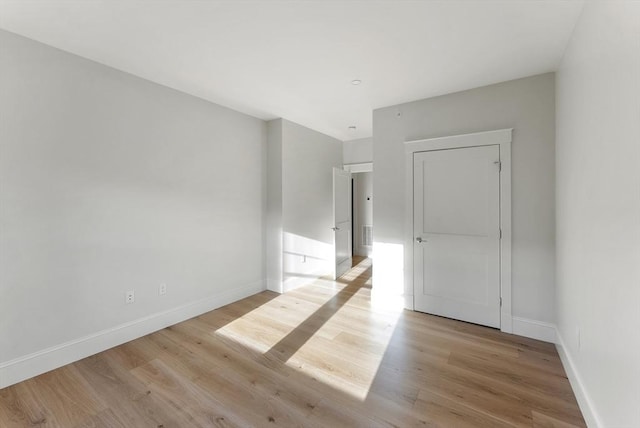 spare room with light hardwood / wood-style floors