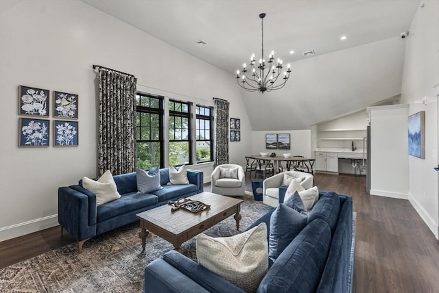 living room with an inviting chandelier, a towering ceiling, and dark hardwood / wood-style floors