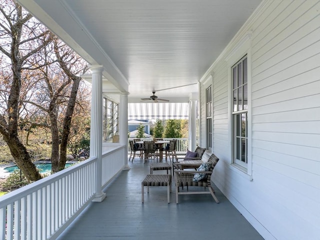 wooden terrace featuring ceiling fan and covered porch
