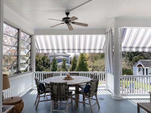 sunroom with ceiling fan and outdoor dining space
