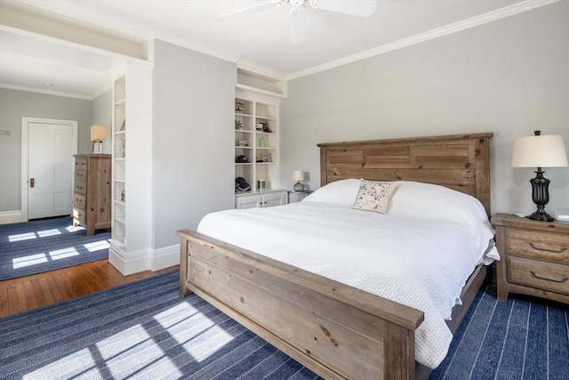 bedroom featuring wood finished floors, ornamental molding, baseboards, and a ceiling fan