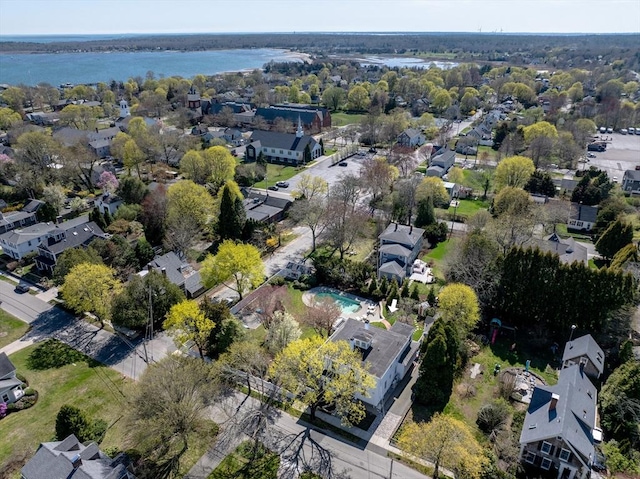 aerial view of property's location featuring a nearby body of water and nearby suburban area