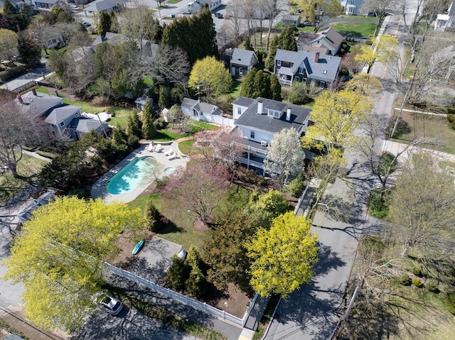 aerial view of property and surrounding area with a pool area and nearby suburban area