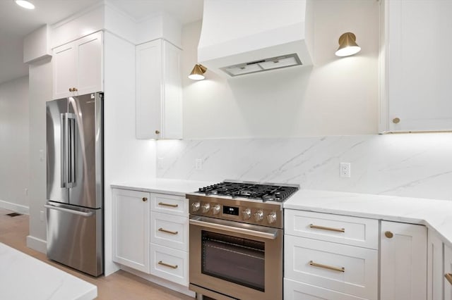 21 Ashland Unit 21, Boston, MA 02122 - kitchen featuring stainless steel appliances, premium range hood, light stone countertops, backsplash, and recessed lighting