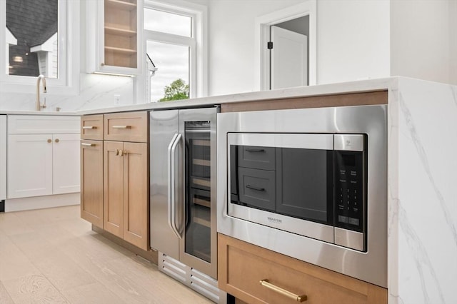 21 Ashland Unit 21, Boston, MA 02122 - kitchen featuring stainless steel microwave, beverage cooler, a sink, and healthy amount of natural light