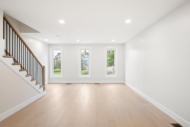 21 Ashland Unit 21, Boston, MA 02122 - unfurnished living room featuring light wood finished floors, baseboards, recessed lighting, and stairs