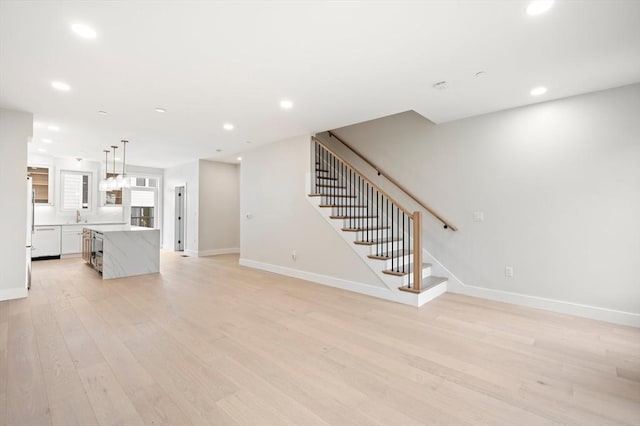 21 Ashland Unit 21, Boston, MA 02122 - unfurnished living room featuring stairway, baseboards, light wood-style floors, recessed lighting, and a sink