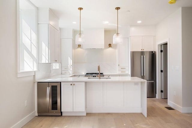 21 Ashland Unit 21, Boston, MA 02122 - kitchen with freestanding refrigerator, fridge, a sink, light countertops, and premium range hood