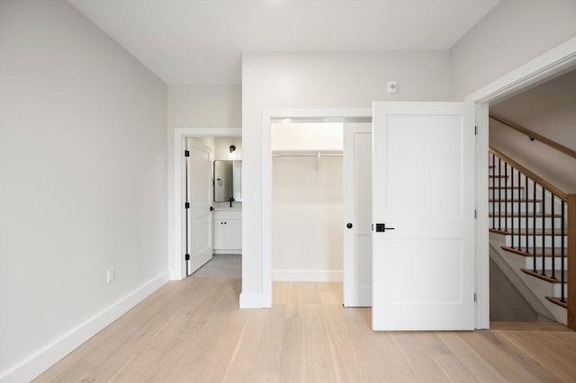 21 Ashland Unit 21, Boston, MA 02122 - unfurnished bedroom featuring light wood-type flooring, baseboards, and a closet