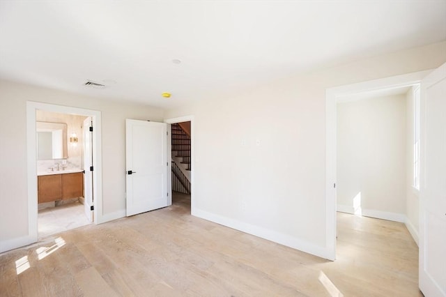 21 Ashland Unit 21, Boston, MA 02122 - unfurnished bedroom featuring light wood-type flooring, baseboards, and ensuite bathroom