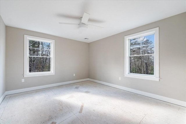 unfurnished room featuring ceiling fan and a healthy amount of sunlight