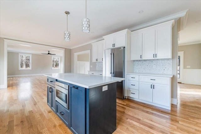 kitchen with white cabinets, ceiling fan, backsplash, and high end refrigerator