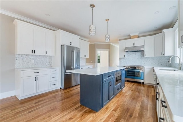 kitchen featuring white cabinets, blue cabinets, hanging light fixtures, sink, and appliances with stainless steel finishes