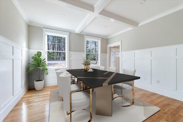 dining area with beam ceiling, light hardwood / wood-style floors, coffered ceiling, and ornamental molding