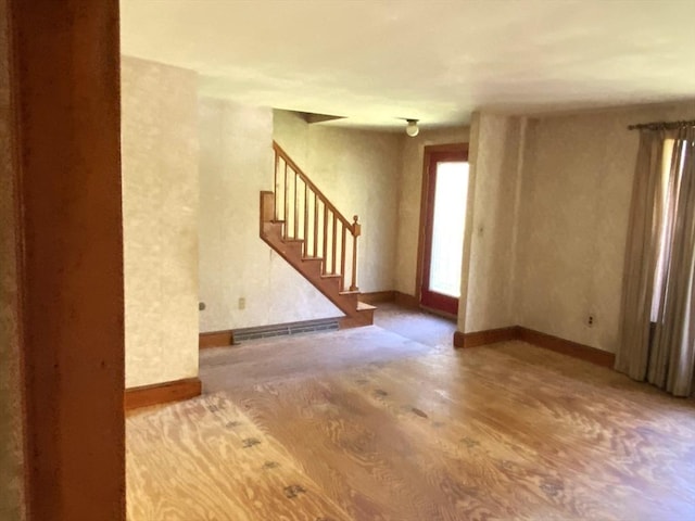 101 Highfields Rd, Abington, MA 02351 - unfurnished living room featuring wood finished floors, stairway, baseboards, and baseboard heating