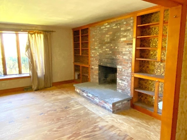 101 Highfields Rd, Abington, MA 02351 - unfurnished living room with a brick fireplace, built in shelves, and baseboards