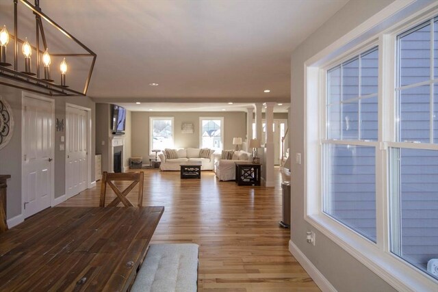 entrance foyer featuring recessed lighting, a fireplace, wood finished floors, and baseboards