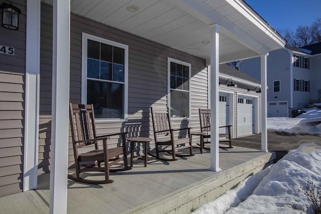 snow covered deck with a porch