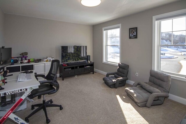 home office with baseboards, a wealth of natural light, and light colored carpet