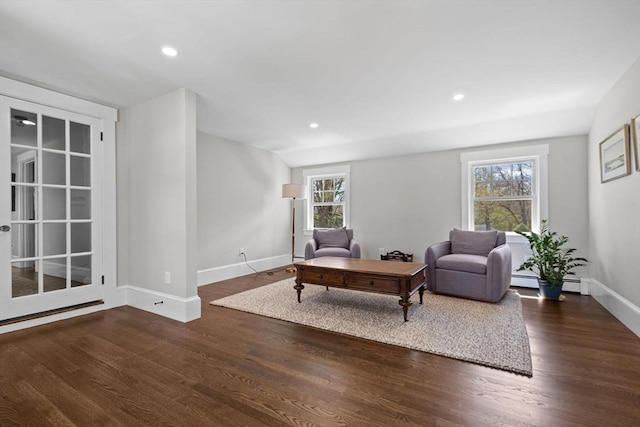 living area featuring recessed lighting, baseboards, wood finished floors, and a baseboard radiator
