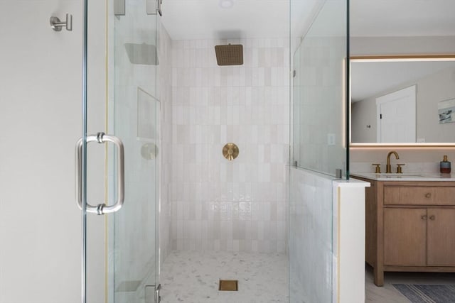bathroom featuring vanity and a shower stall