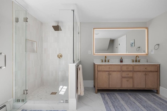 full bath with double vanity, a sink, marble finish floor, and a shower stall