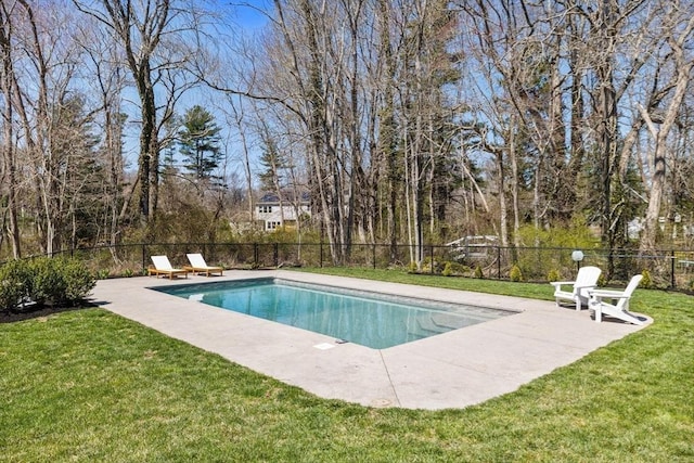 view of swimming pool with a lawn, fence, a fenced in pool, and a patio