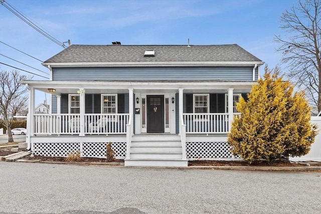 bungalow-style house with covered porch and roof with shingles