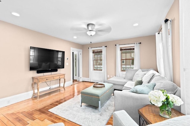 living area featuring recessed lighting, wood-type flooring, a ceiling fan, and baseboards