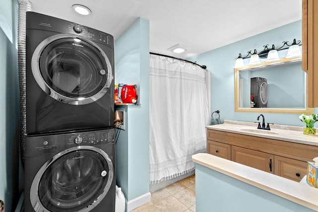 laundry area featuring stacked washer and dryer, laundry area, a sink, and light tile patterned floors