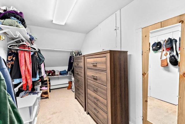 walk in closet with lofted ceiling, baseboard heating, and light colored carpet