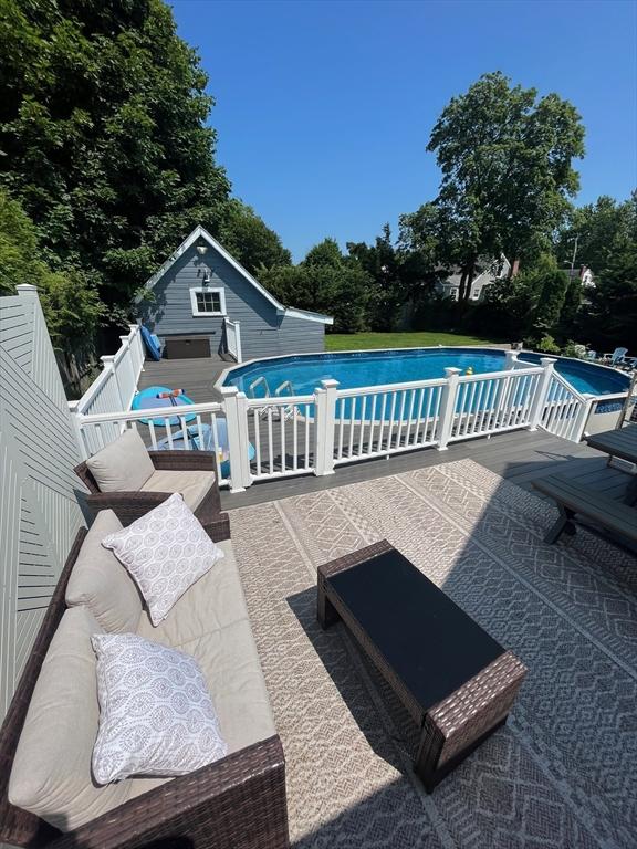 pool with a patio area and an outdoor structure