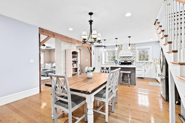 dining room featuring a notable chandelier, light wood finished floors, recessed lighting, stairway, and baseboards