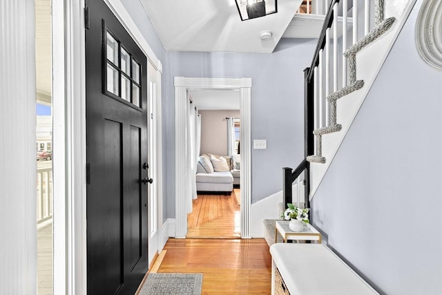 foyer featuring light wood finished floors and stairway