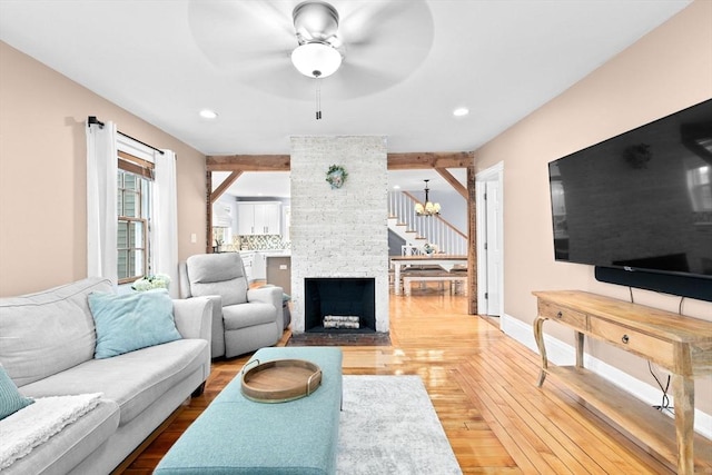 living room with a fireplace, recessed lighting, ceiling fan, wood finished floors, and baseboards