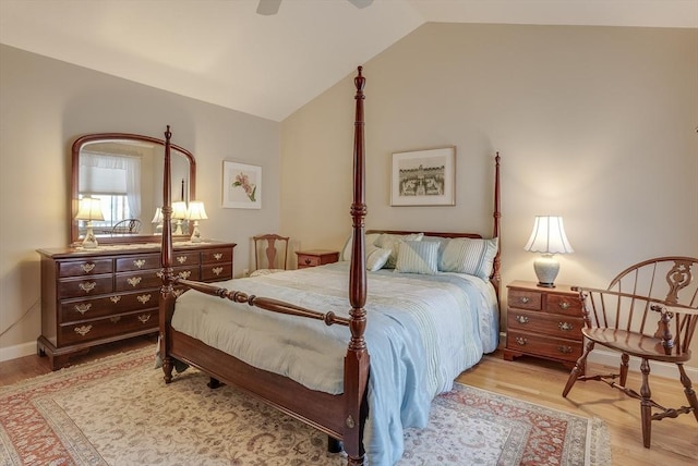 bedroom featuring ceiling fan, lofted ceiling, and light wood-type flooring