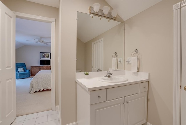 bathroom with tile patterned flooring, vanity, lofted ceiling, and ceiling fan