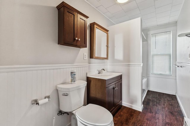 full bathroom with hardwood / wood-style floors, plenty of natural light, shower / bath combination, toilet, and vanity