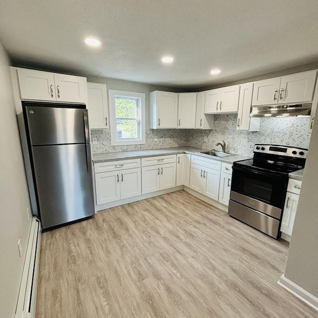 16A Exeter St, Lawrence, MA 01843 - kitchen with appliances with stainless steel finishes, under cabinet range hood, a baseboard heating unit, white cabinets, and recessed lighting