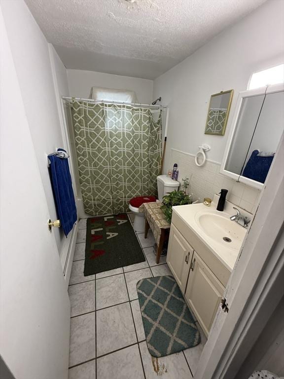 16A Exeter St, Lawrence, MA 01843 - full bath featuring vanity, a textured ceiling, tile patterned flooring, and shower / tub combo with curtain