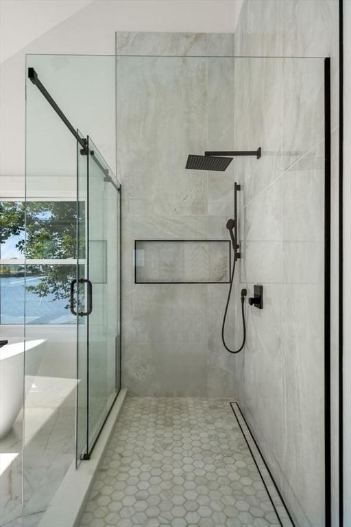 full bath with a stall shower, a soaking tub, and tile patterned floors