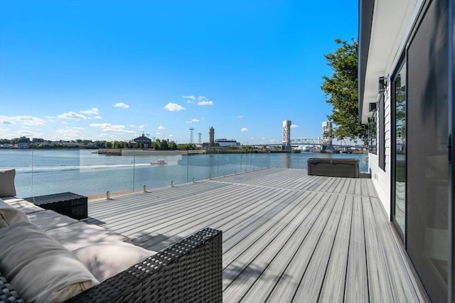 wooden deck featuring a water view and a jacuzzi