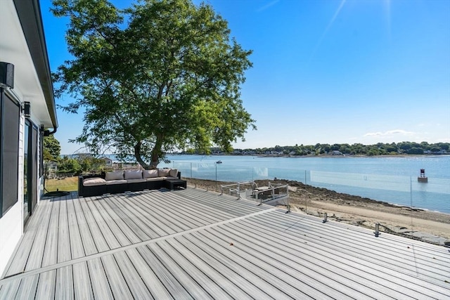 wooden deck with a water view and an outdoor living space