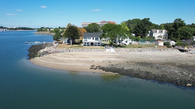 drone / aerial view with a water view and a beach view