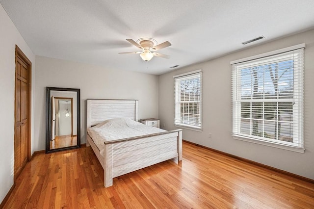 bedroom featuring ceiling fan and light hardwood / wood-style floors