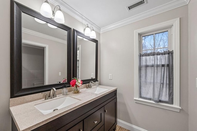 bathroom with ornamental molding, a notable chandelier, and vanity