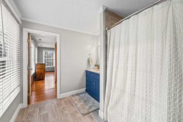 bathroom featuring crown molding, vanity, and a shower with curtain