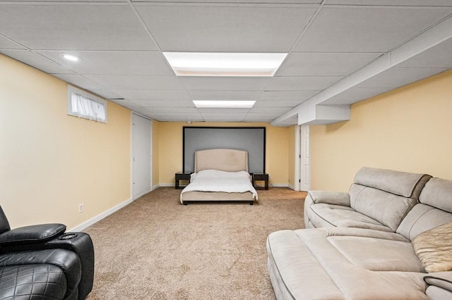 bedroom featuring carpet floors and a drop ceiling